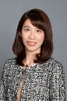 A person with brown hair wearing a black and white jacket

Description automatically generated